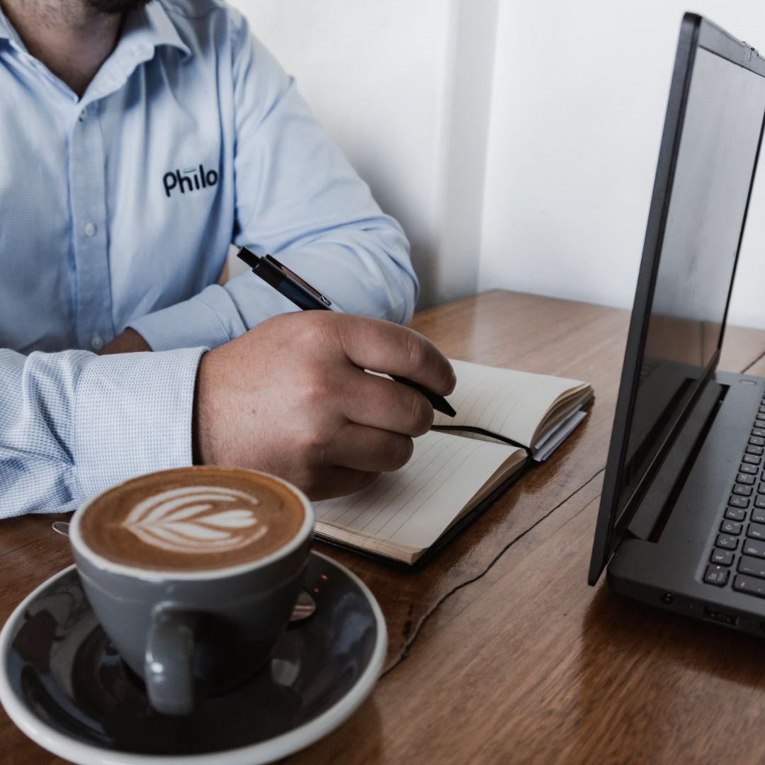 A Philo team member planning software beside a laptop
